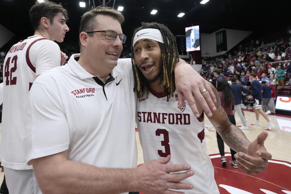 Stanford head coach Jerod Haase, left, celebrates with guard Kanaan Carlyle (3) after a victory against Arizona in a NCAA college basketball game, Sunday, Dec. 31, 2023, in Stanford, Calif. (AP Photo/Tony Avelar)