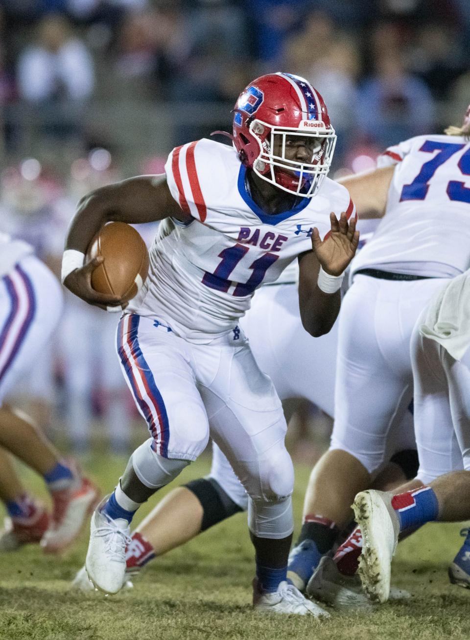 Ben Tyner (11) carries the ball during the Pace vs Navarre football game at Navarre High School on Friday, Oct. 21, 2022.