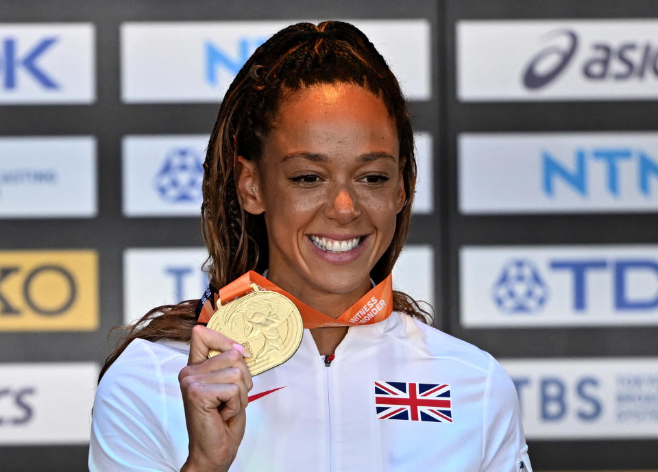 Katarina Johnson-Thompson celebrates on the podium with her medal after winning the Women's Heptathlon final at the 2023 World Championships (REUTERS/Dylan Martinez)