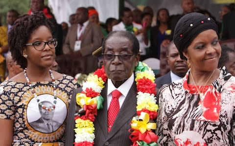 Bona Mugabe, left, with her father and mother - Credit: AP