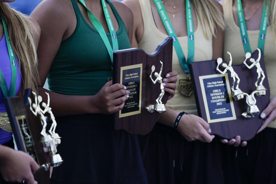 Mason's Shyla Aggarwal, center, holds her Division I singles championship plaque during the OHSAA state tennis tournament at the Lindner Family Tennis Center on Saturday, Oct. 22, 2022.