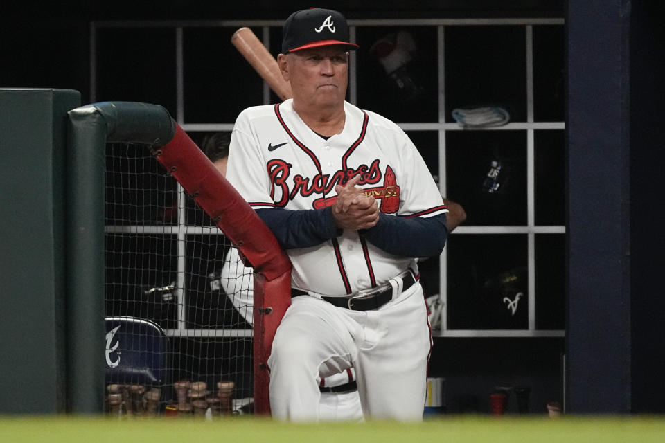 Atlanta Braves manager Brian Snitker watches from the dugout during the team's baseball game against the Cincinnati Reds on Wednesday, April 12, 2023, in Atlanta. (AP Photo/John Bazemore)