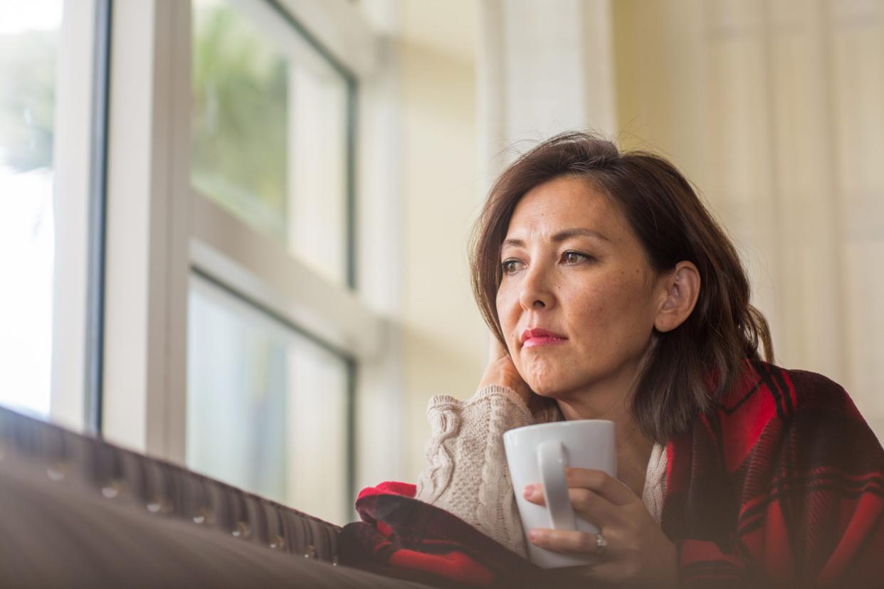 Unhappy woman looking out the window.