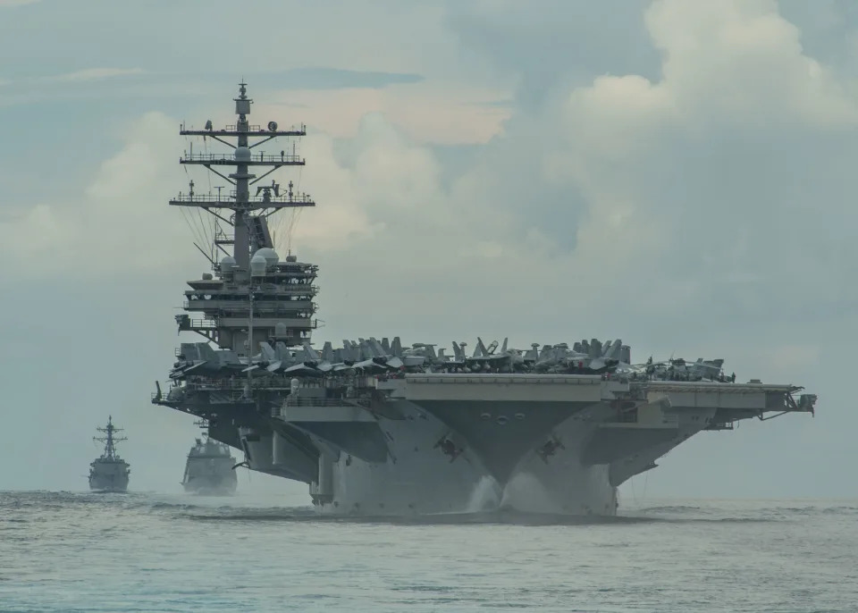 From right, the Nimitz-class aircraft carrier USS Ronald Reagan (CVN 76), the Japan Maritime Self-Defense Force Akizuki-class destroyer JS Teruzuki (DD 116) and the Arleigh Burke-class destroyer USS Mustin (DDG 89) sail in formation in the Philippine Sea, July 19, 2020. Picture taken July 19. 2020.  U.S. Navy photo by Mass Communication Specialist 3rd Class James Hong/Handout via REUTERS  ATTENTION EDITORS - THIS IMAGE HAS BEEN SUPPLIED BY A THIRD PARTY. To match Special Report USA-CHINA/BOMBERS