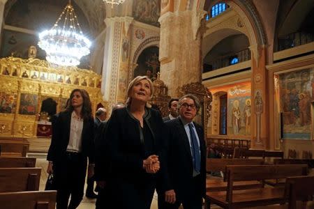 Marine Le Pen, French National Front (FN) political party leader and candidate for French 2017 presidential election, and French deputy Gilbert Collard visit Saint George Orthodox Cathedral in Beirut, Lebanon February 20, 2017. REUTERS/Mohamed Azakir