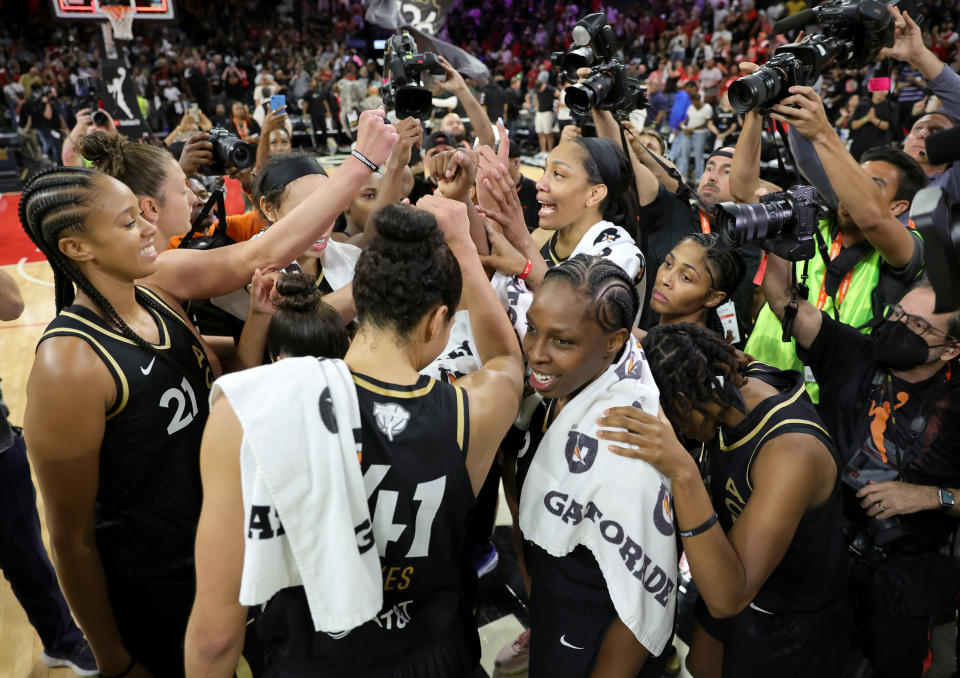 Las Vegas Aces players hug on the court after the team's 85-71 win over the Connecticut Sun in Game 2 of the 2022 WNBA Finals at Misheb ULTRA Arena on Sept. 13, 2022 in Las Vegas.  (Ethan Miller/Getty Images)