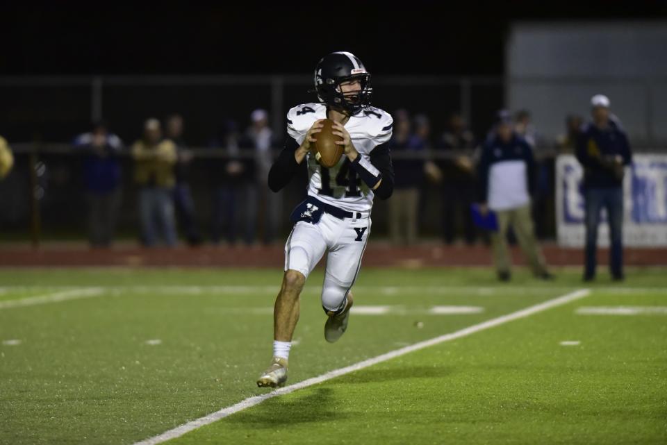 Yale quarterback Connor Jakubiak looks to throw a pass during the Bulldogs' 42-7 loss to Marine City in a Division 5 district semifinal at East China Stadium on Friday. He ran for 59 yards and one touchdown on nine carries.