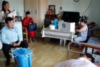 A woman fills out her ballot in a private home as she remotely votes in the upcoming presidential election in Zuunmod, Tuv Aimag, Mongolia, June 25, 2017. REUTERS/B. Rentsendorj