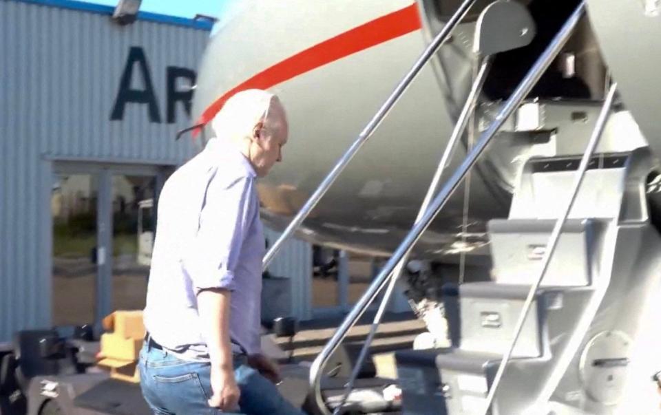 Julian Assange boards a plane from London Stansted Airport