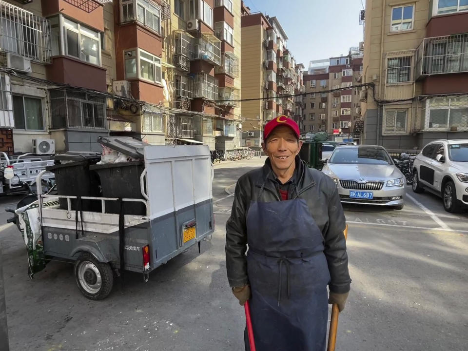 Duan Shuangzhu, 68, a waste collector who moved to Beijing in late 1990s from a small village in central China's Shanxi, stands near a rubbish cart while working in Beijing on March 1, 2024. China’s first generation of migrant workers played an integral role in the country's transformation from an impoverished nation to an economic powerhouse. Now, they're finding it hard to find work, both because they're older and the economy is slowing. (AP Photo)