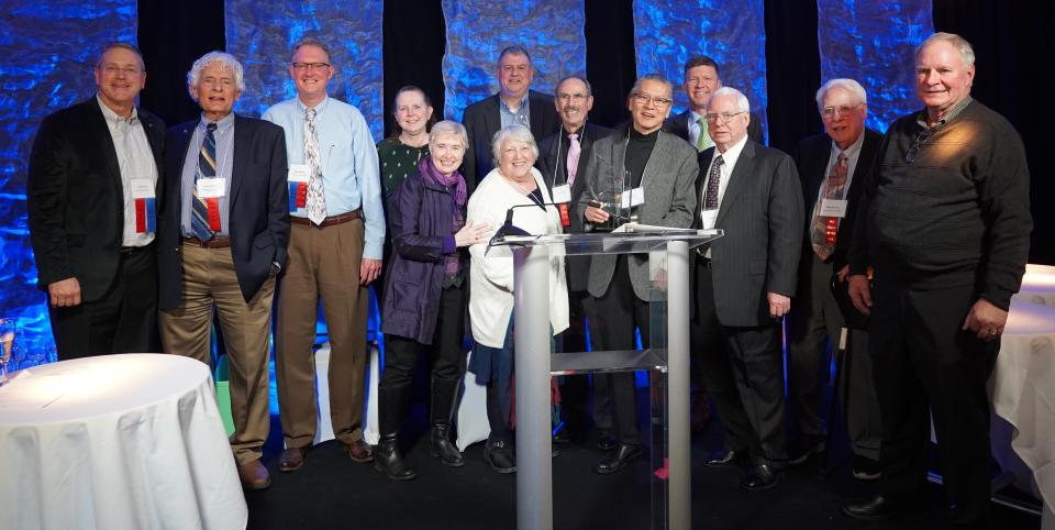 Photographer Richard Lim (center in gray jacket) is surrounded by local officials and other movers and shakers after being named the "2023 Citizen of the Year" by the Howell Area Chamber of Commerce and its annual awards banquet Thursday, Jan. 26, 2024.