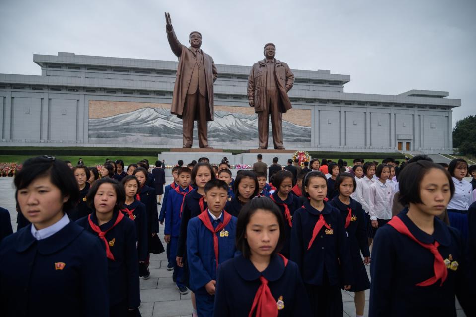 Students visit the statues of late North Korean leaders Kim Il Sung and Kim Jong Il in Pyongyang in October 2019.