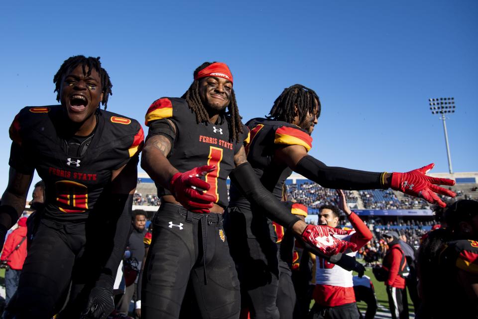 From left, Ferris State defensive back Jacarvis Alexandre (0), defensive back Sidney McCloud (1) and defensive back Ade Kilpatrick (4) celebrate as the clock winds down in the second half of the NCAA Division II football championship against the Colorado School of Mines on Saturday, Dec. 17, 2022 in McKinney, Texas. Ferris State won the game by a final of 41-14.
