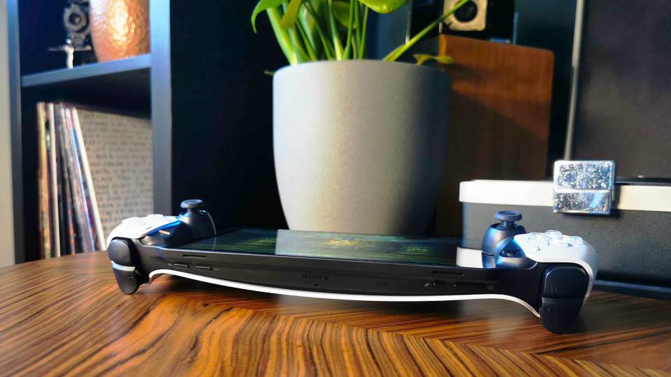 PlayStation Portal lying down on woodgrain table