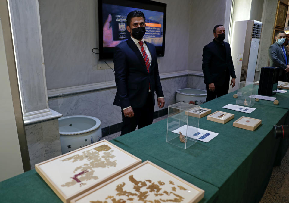 Recently recovered antiquities are displayed at the foreign ministry, in Baghdad, Iraq, Tuesday, Aug. 3, 2021. Over 17,000 looted ancient artefacts recovered from the United States and other countries were handed over to Iraq's Culture Ministry on Tuesday, a restitution described by the government as the largest in the country's history. The majority of the artefacts date back 4,000 years to ancient Mesopotamia and were recovered from the U.S. in a recent trip by Prime Minister Mustafa al-Kadhim. (AP Photo/Khalid Mohammed)