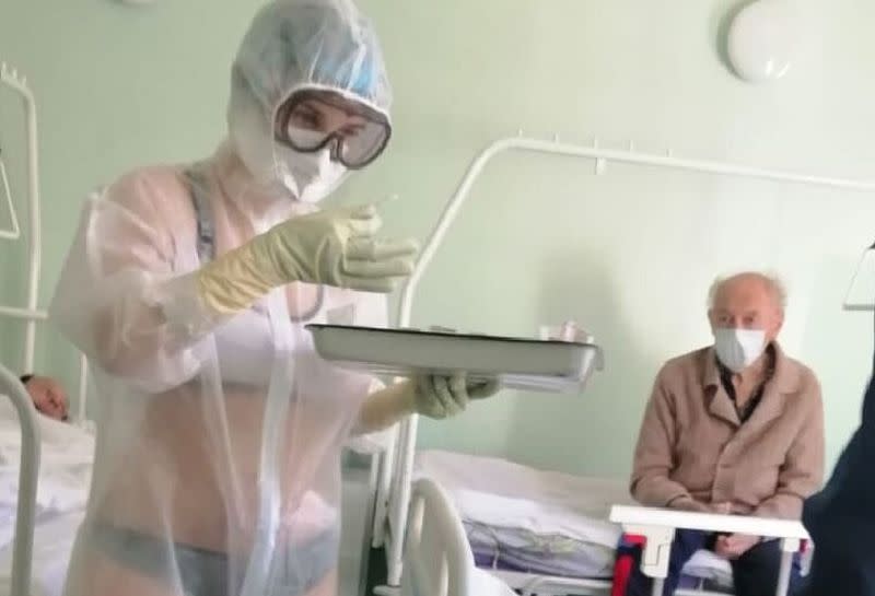 The viral image of a Russian nurse in what appears to be a bikini treating Covid-19 patients in a male-only ward. — Picture via Twitter/_MariettaDavis