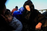 <p>A woman and child who just fled a village controlled by Islamic State militants head to a camp at Hamam al-Alil, south of Mosul, Iraq, Feb. 22, 2017. (Zohra Bensemra/Reuters) </p>