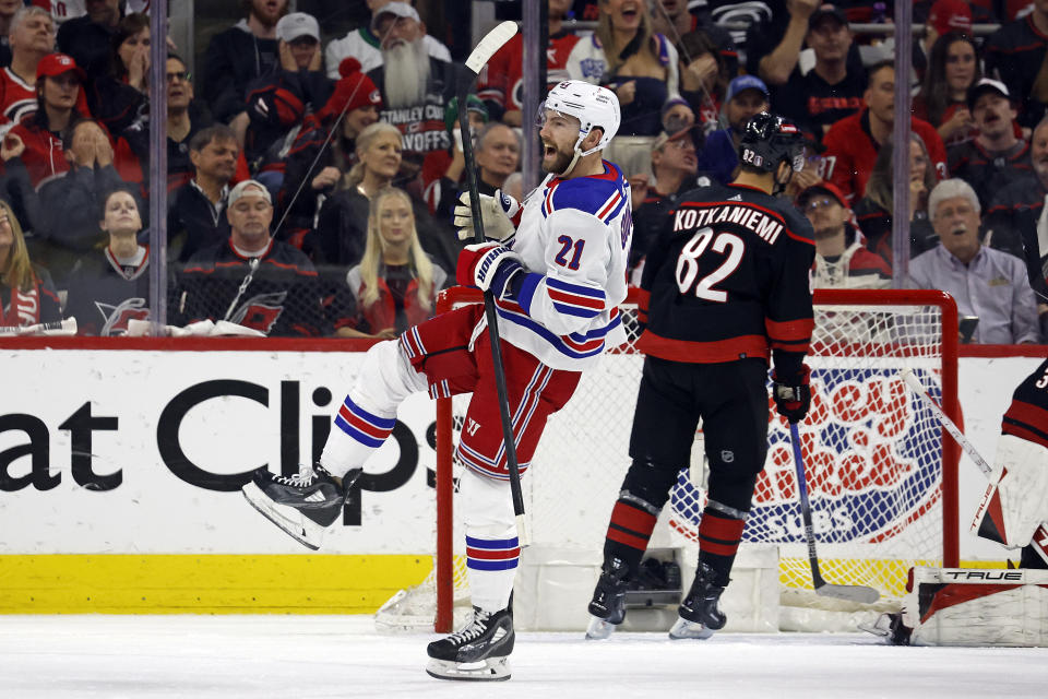 New York Rangers' Barclay Goodrow (21) celebrates after his goal with Carolina Hurricanes' Jesperi Kotkaniemi (82) nearby during the second period in Game 4 of an NHL hockey Stanley Cup second-round playoff series in Raleigh, N.C., Saturday, May 11, 2024. (AP Photo/Karl B DeBlaker)