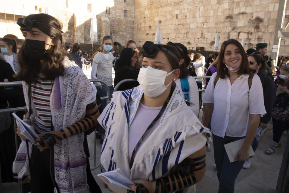 Members of the Women of the Wall wearing tefillin after the Rosh Hodesh, or new month prayer in the women's section at the Western Wall, the holiest site where Jews can pray, in the Old City of Jerusalem, Friday, Nov. 5, 2021. Thousands of ultra-Orthodox Jews gathered at the site to protest against the Jewish women's group that holds monthly prayers there in a long-running campaign for gender equality at the site. (AP Photo/Maya Alleruzzo)