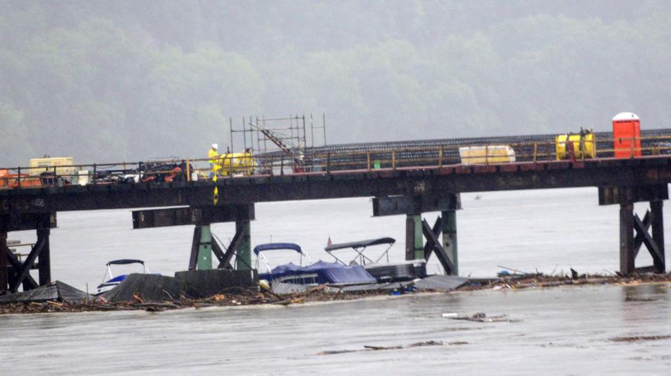 Boats that got swept away from the marina on the West River in Brattleboro from the heavy rains get caught up in the new bridge project over the Connecticut River between Hinsdale N.H., and Brattleboro, Vt., Monday, July 10, 2023. (Kristopher Radder/The Brattleboro Reformer via AP)