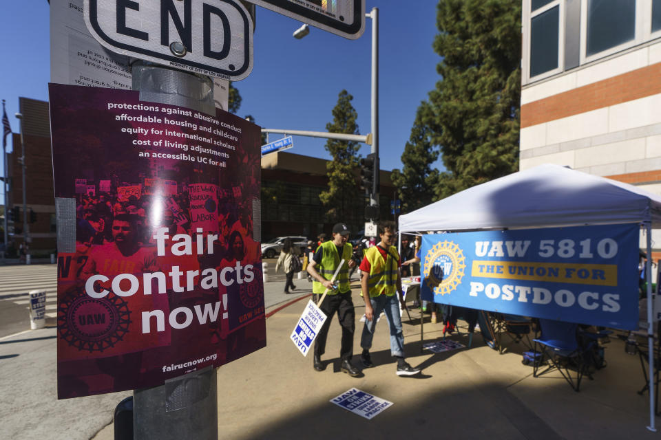 FILE - People participate in a protest outside the UCLA campus in Los Angeles, Monday, Nov. 14, 2022. The University of California has reached an agreement with some 36,000 graduate student teaching assistants and other academic workers for increased pay and benefits that could potentially end the month-long strike at the prestigious state system. The strike disrupted classes at all 10 of the university system's campuses and was the largest strike of academic workers in the nation. The agreement still needs to be ratified before the strike officially ends. (AP Photo/Damian Dovarganes, File)