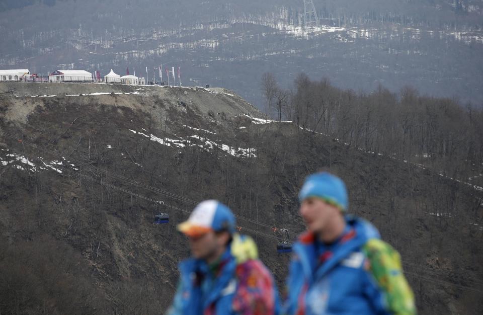 An inter-mingling of snow and brown patches are seen near the alpine course at the Sochi 2014 Winter Olympics, Tuesday, Feb. 11, 2014, in Krasnaya Polyana, Russia. Warm temperatures in the mountains made the snow too soft and caused the cancellation of Women's downhill training on Tuesday. (AP Photo/Christophe Ena)