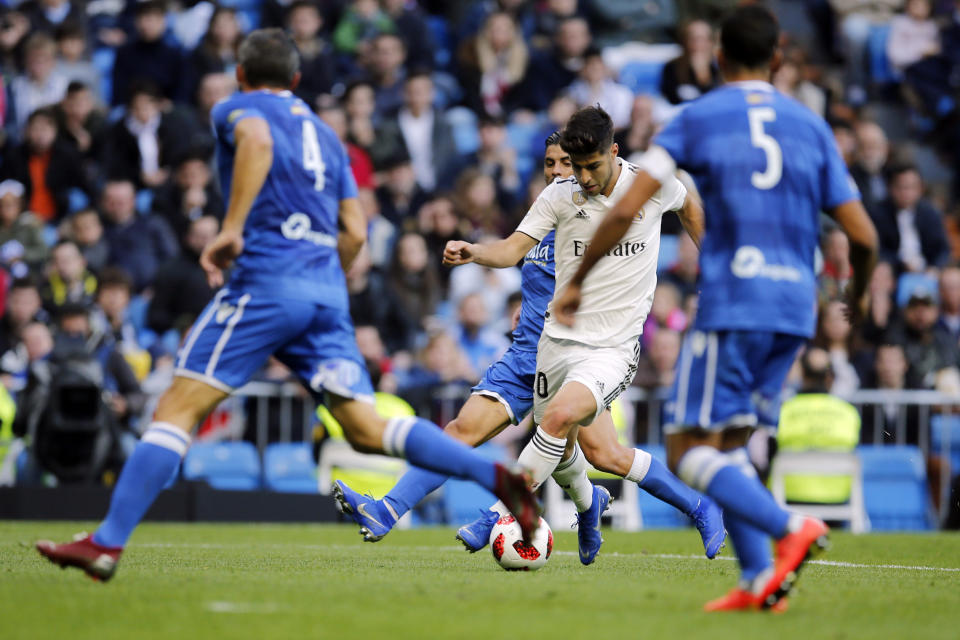 Real Madrid's Marco Asensio prepares to shoot to score the opening goal during a round of 32, 2nd leg, Spanish Copa del Rey soccer match between Real Madrid and Melilla at the Santiago Bernabeu stadium in Madrid, Spain, Thursday, Dec. 6, 2018. (AP Photo/Paul White)