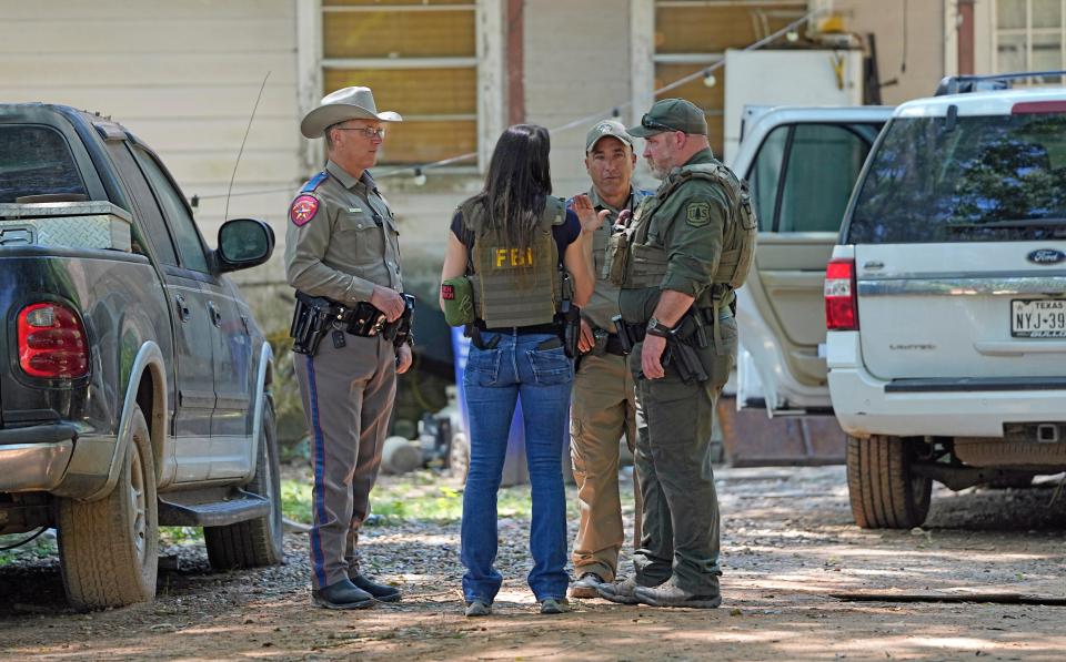 Law enforcement officials investigated the neighborhood Sunday where a deadly mass shooting occurred in Cleveland, Texas, on Friday.