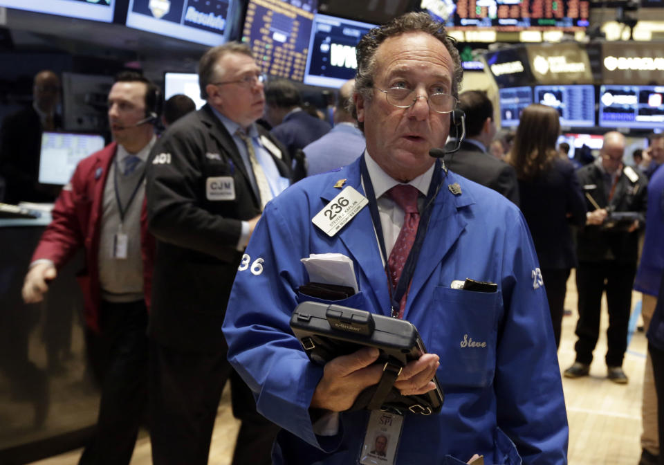 Trader Steven Kaplan, center, works on the floor of the New York Stock Exchange Tuesday, Feb. 4, 2014. Stocks are mixed on Wall Street after suffering big losses the day before. (AP Photo/Richard Drew)