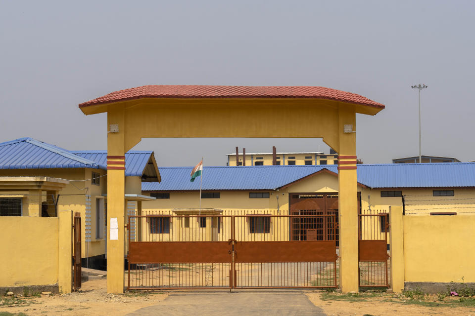 A security person guards the gate of a detention center where where suspected immigrants are held in Matiya village, northeastern Assam state, India, April 17, 2023. Nearly 2 million people, or over 5% of Assam's population, could be stripped of their citizenship unless they have documents dating back to 1971 that show their ancestors entered the country legally from neighboring Bangladesh. (AP Photo/Anupam Nath)