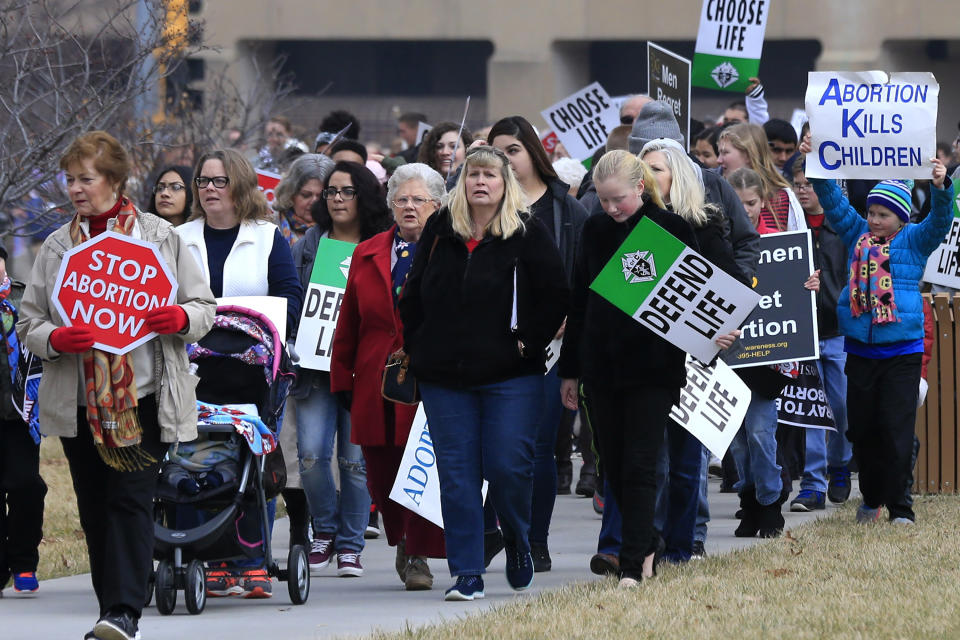 FILE - In this Jan. 23, 2017, file photo, marchers arrive for a Roe v. Wade protest as hundreds converge on the Kansas Statehouse in Topika, Kan. Top Kansas Republicans are pushing to overturn a state Supreme Court decision that protects abortion rights but say they can't get enough support to ban abortion.The Legislature expects to consider a proposed amendment to the Kansas Constitution during the annual 90-day lawmaking session set to convene Monday, Jan. 13, 2020. It's a response to the state high court's ruling in April that the state's Bill of Rights makes access to abortion a fundamental right. (AP Photo/Orlin Wagner, File)