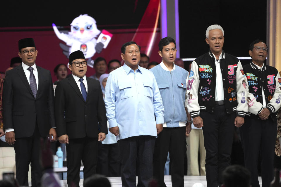 FILE - Presidential candidates, from left, Anies Baswedan and his running mate Muhaimin Iskandar, Prabowo Subianto and his running mate the eldest son of Indonesian President Joko Widodo Gibran Rakabuming Raka, and Ganjar Pranowo and his running mate Mahfud MD stand on the stage as they sing a national song "For You My Country" after a televised presidential candidates' debate in Jakarta, Indonesia Sunday, Feb. 4, 2024. When millions of Indonesians pick their new president in one of the world's biggest elections on Feb. 14, the United States and China would be closely watching who will next lead a key Asian battleground coveted for its huge market, nickel and voice. (AP Photo/Achmad Ibrahim, File)