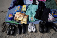 Secondhand garments and some food products are displayed at a market where people can buy or barter goods, on the outskirts of Buenos Aires, Argentina, Wednesday, Aug. 10, 2022. Argentina has one of the world’s highest inflation rates, currently running at more than 60% annually, according to the National Institute of Statistics and Census of Argentina (INDEC). (AP Photo/Natacha Pisarenko)