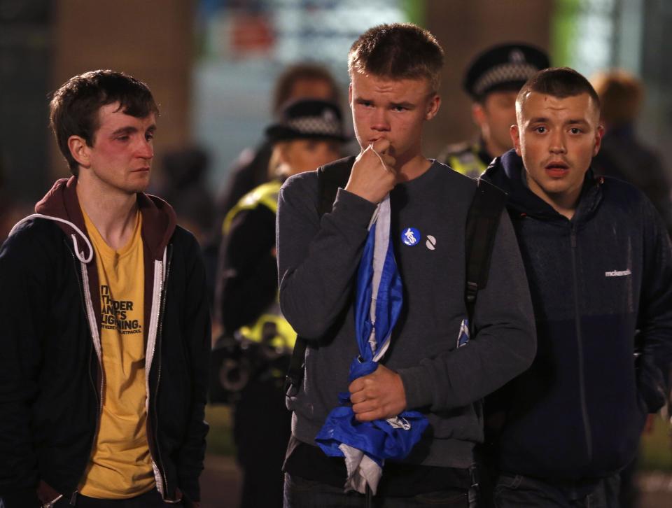 Supporters from the "Yes" Campaign react as they stand in George Square in Glasgow, Scotland