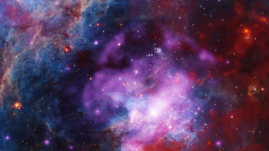  A view of purple, blue and white glowing hazes concentrated in the center of the image. 