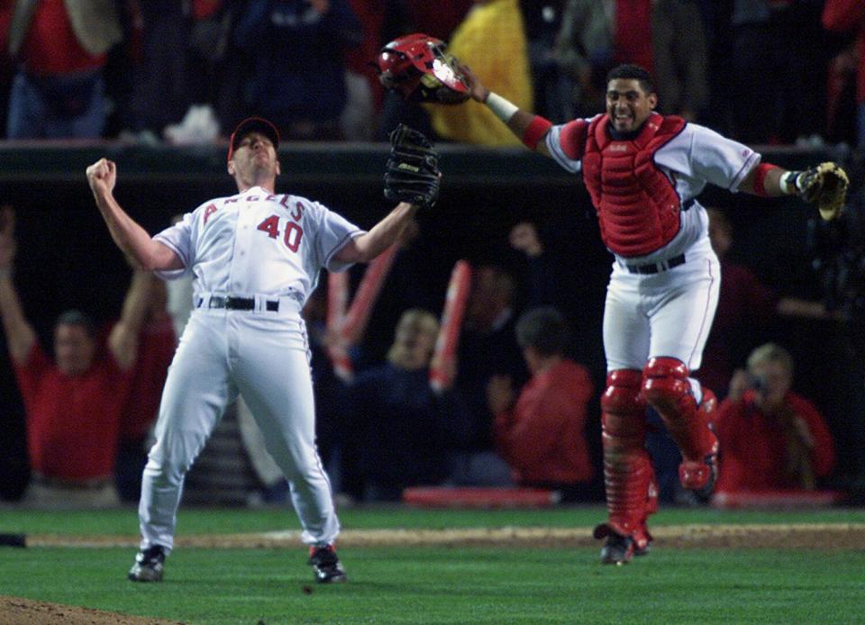 Angels relief pitcher Troy Percival and catcher Bengie Molina celebrate the team's 2002 World Series win over the Giants.