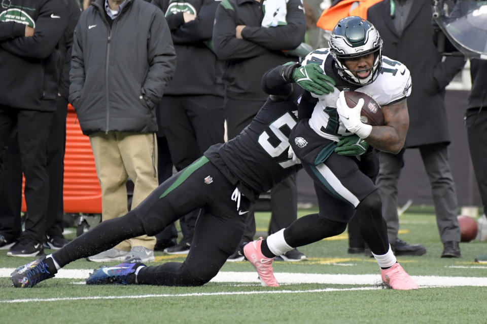 Philadelphia Eagles running back Kenneth Gainwell (14) runs the ball against New York Jets middle linebacker C.J. Mosley (57) during the first half of an NFL football game, Sunday, Dec. 5, 2021, in East Rutherford, N.J. (AP Photo/Bill Kostroun)