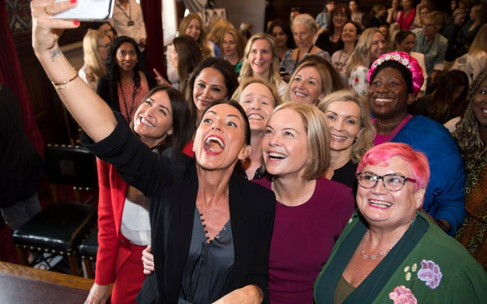 Campaigners from Menopause Mandate in Parliament including Lisa Snowden, front left, Davina McCall, taking picture and Mariella Frostrup, the group's chair - MURRAY SANDERS