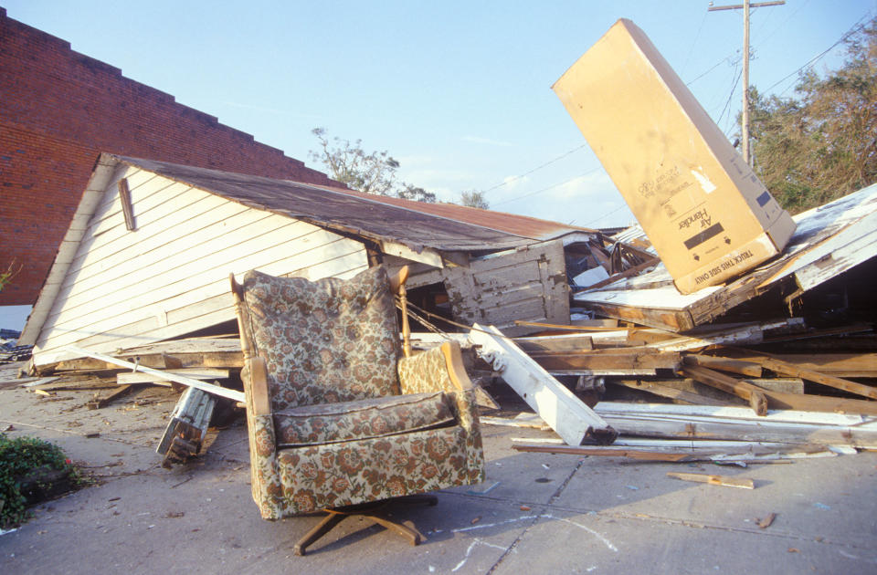 <p>An armchair and a gabled roof in one piece while the rest of a Jeanerette, Louisiana, house lies in ruins after Hurricane Andrew, 1992 (Visions of America/UIG via Getty Images) </p>