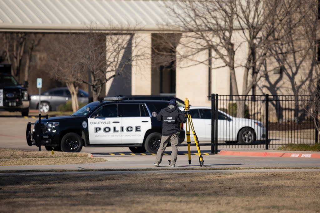 Police process the scene in front of the Congregation Beth Israel synagogue in Colleyville, Texaswhere Malik Faisal Akram was shot dead by the FBI  (AP)