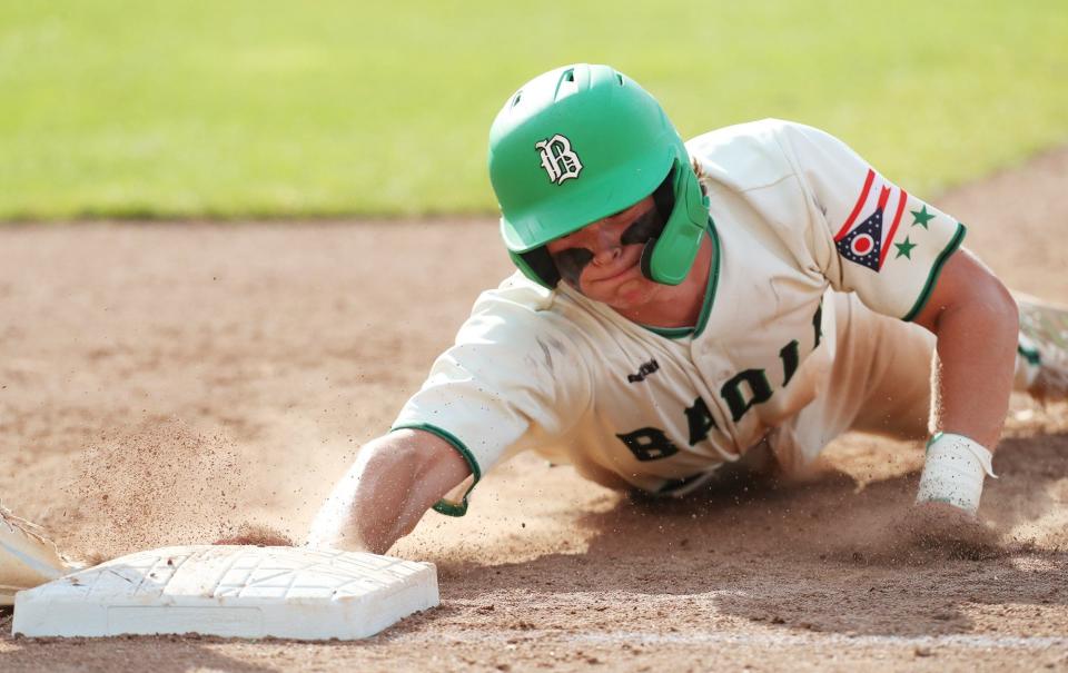 Badin's Jimmy Nugent dives safely back to first base on a pick-off attempt by Archbishop Hoban pitcher in the seventh inning of the Division II state semifinal game at Canal Park in Akron on Friday, June 9, 2022.