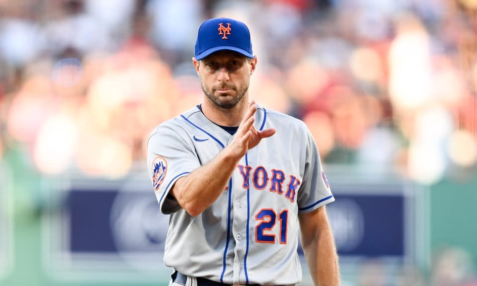 New York Mets starting pitcher Max Scherzer (21) signals before throwing in the first inning of a game against the Boston Red Sox at Fenway Park.