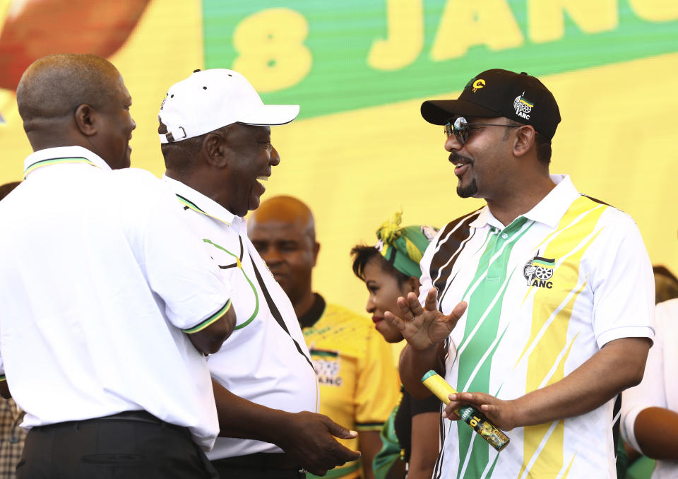 Ethiopian Prime Minister Abiy Ahmed Ali, right, talks with African National Congress (ANC) president and South African President Cyril Ramaphosa at the party's 108th birthday celebrations in Kimberley, South Africa, Saturday, Jan. 11, 2020. (AP Photo)