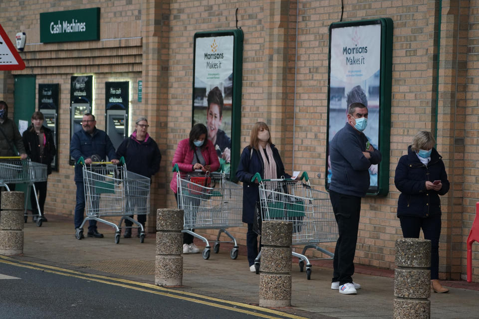 People queue outside a Morrisons supermarket in Whitley Bay, Tyne and Wear. Prime Minister Boris Johnson cancelled Christmas for almost 18 million people across London and eastern and south-east England following warnings from scientists of the rapid spread of the new variant of coronavirus. (Photo by Owen Humphreys/PA Images via Getty Images)