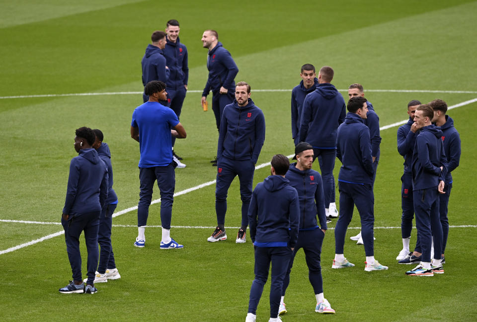 England's Harry Kane, center, walks with teammates on the field before the Euro 2020 final soccer match between Italy and England at Wembley stadium in London, Sunday, July 11, 2021. (Facundo Arrizabalaga/Pool via AP)