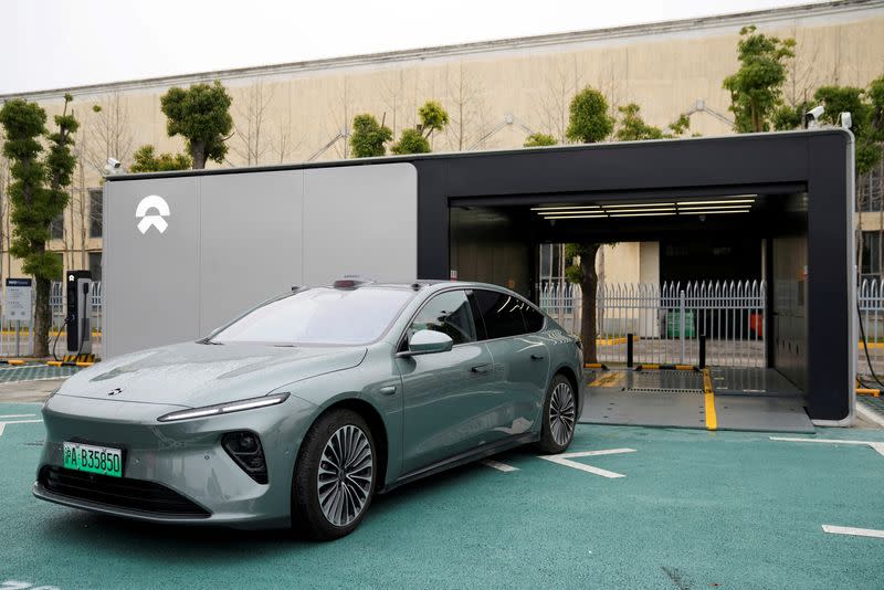 FILE PHOTO: Security guard stands near a delivery center of Chinese electric vehicle (EV) maker Nio in Nanxiang