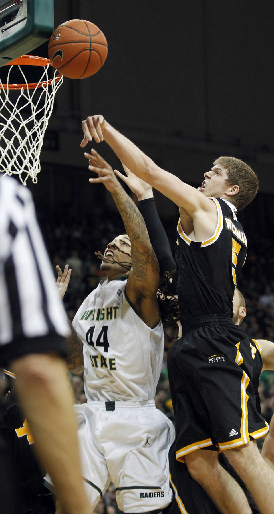 Milwaukee's Cody Whichmann, right, blocks a shot by Wright State's Tavares Sledge during the Horizon League men's tournament championship, Tuesday, March 11, 2014, in Dayton, Ohio. (AP Photo/The Dayton Daily News, Ty Greenlees) LOCAL PRINT OUT; LOCAL TV OUT; WKEF-TV OUT; WRGT-TV OUT; WDTN-TV OUT (REV-SHARE)