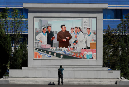 A cameraman films a painting of late North Korean leader Kim Jong Il during a government organised trip for foreign reporters in Pyongyang, North Korea, September 8, 2018. REUTERS/Danish Siddiqui