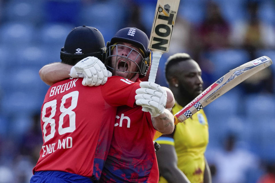 England's batsmen Harry Brook, left, and Phil Salt celebrate defeating West Indies' by seven wickets with one ball remaining during the third T20 cricket match at National Cricket Stadium in Saint George's, Grenada, Saturday, Dec. 16, 2023. (AP Photo/Ricardo Mazalan)