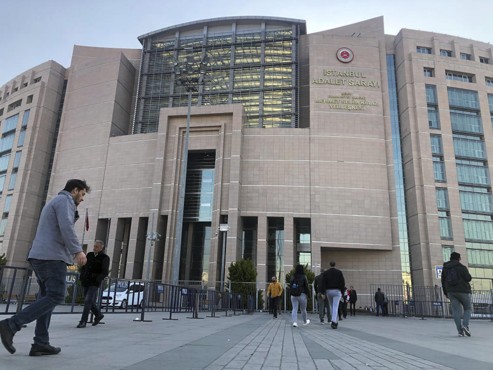 CORRECTS SPELLING OF PHOTOGRAPHERS NAME People walk to the Justice Palace as a trial against Metin Topuz, a Turkish employee of the United States Consulate in Istanbul charged with espionage and attempting to overthrow the Turkish government, began in Istanbul, Tuesday, March 26, 2019. Topuz, a translator and fixer for the Drug Enforcement Agency at the consulate, will have his first hearing Tuesday. He has been in pre-trial detention since October 2017. (AP Photo/Mehmet Guzel)